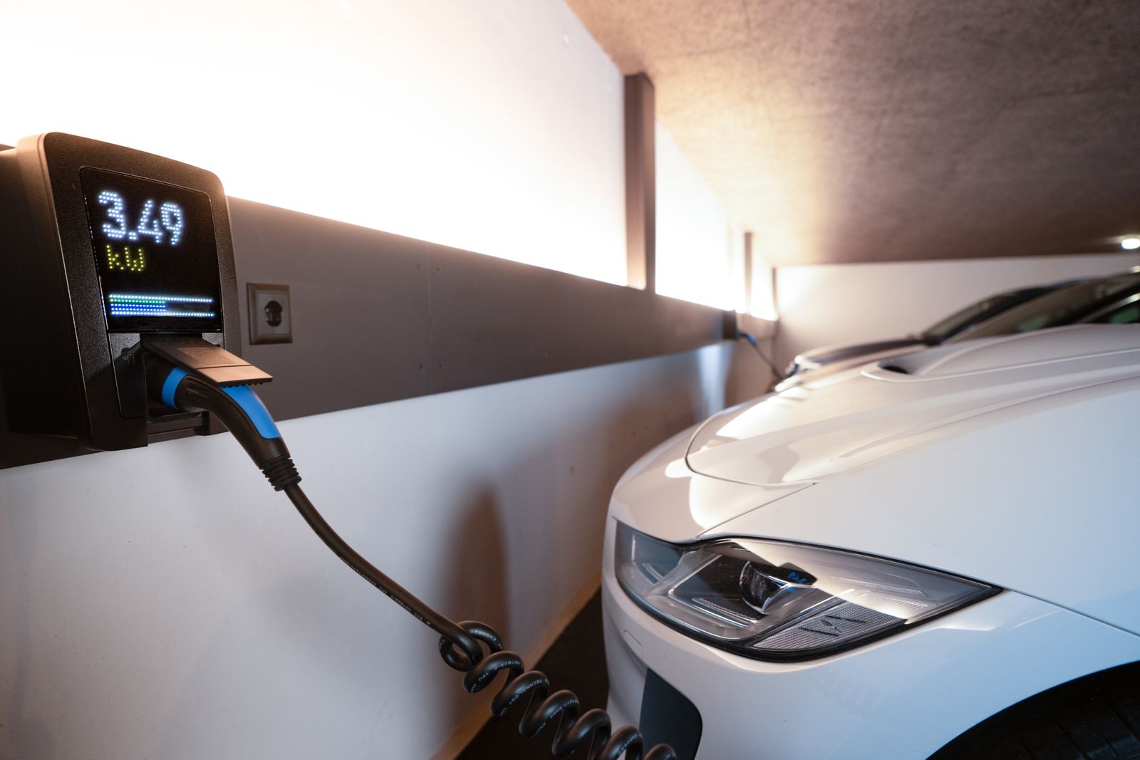 A Level 2 electric vehicle charger mounted on a garage wall