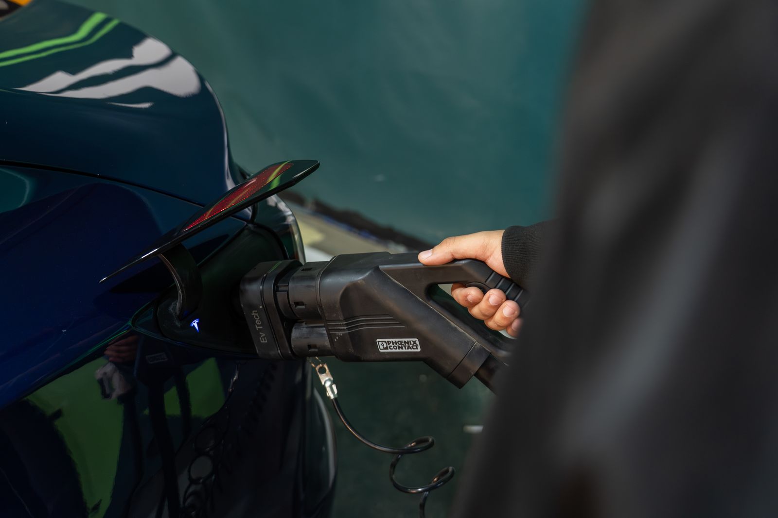 An electric vehicle connected to a charger