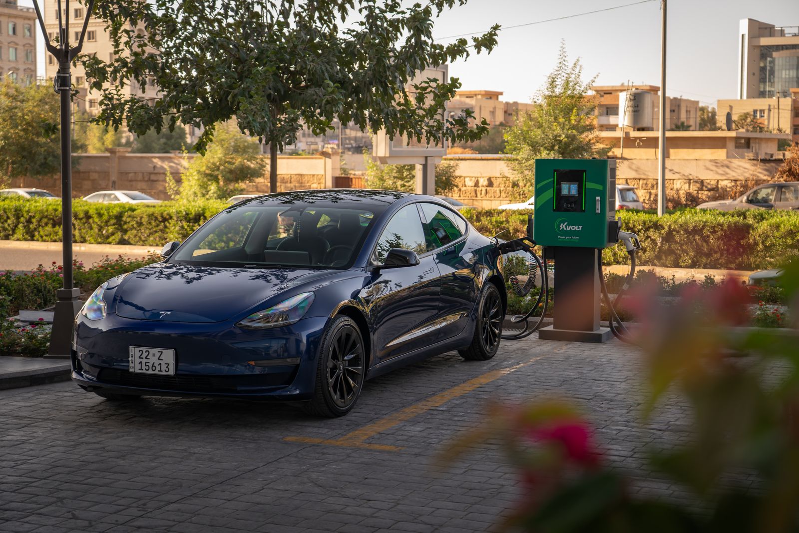 An electric car charging at a public fast charging station