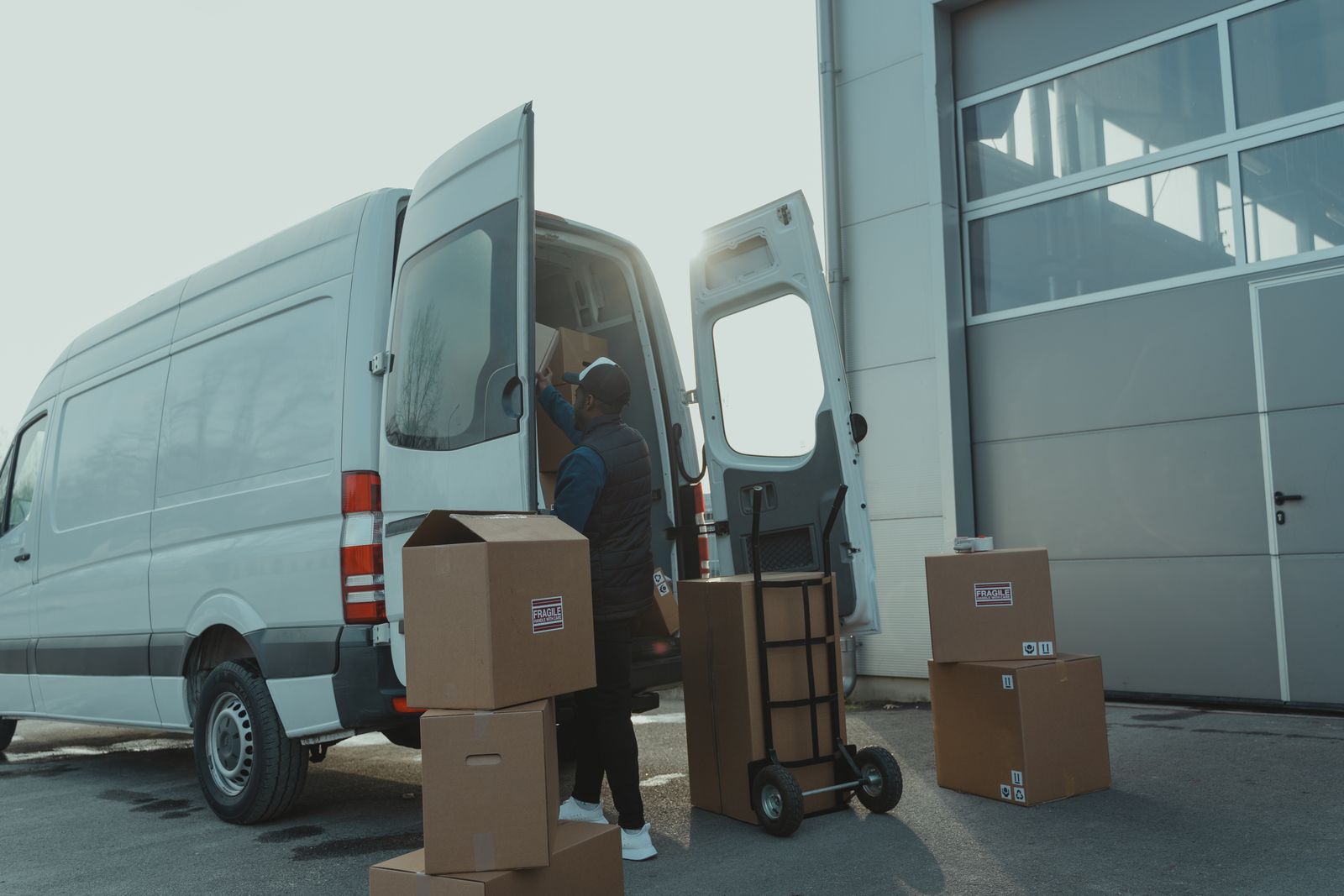 Commercial vans parked outside a warehouse
